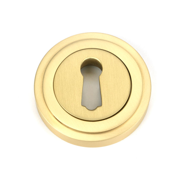 From The Anvil's Satin Brass Round Escutcheon