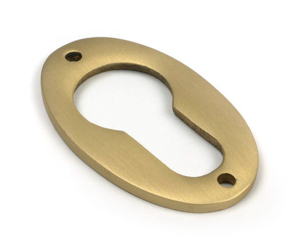From The Anvil's Satin Brass Oval Euro Escutcheon
