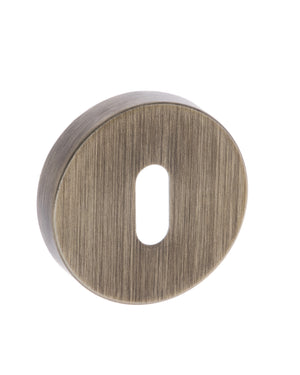 Forme Key Escutcheons on Minimal Round Rose - Yester Bronze by Atlantic Hardware
