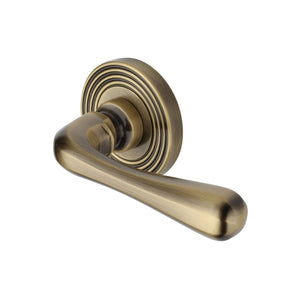 Charlbury Reeded Door Handle on Round Rose by M Marcus - Heritage Brass