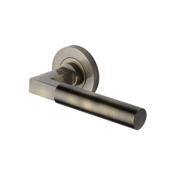 Spectral Door Handle on Round Rose by M Marcus - Heritage Brass